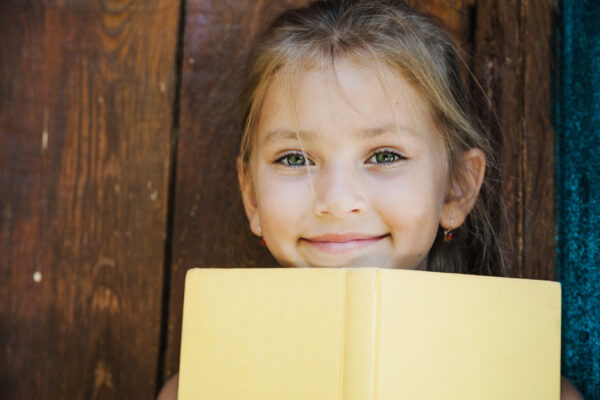 Young student holding a book – building reading comprehension skills