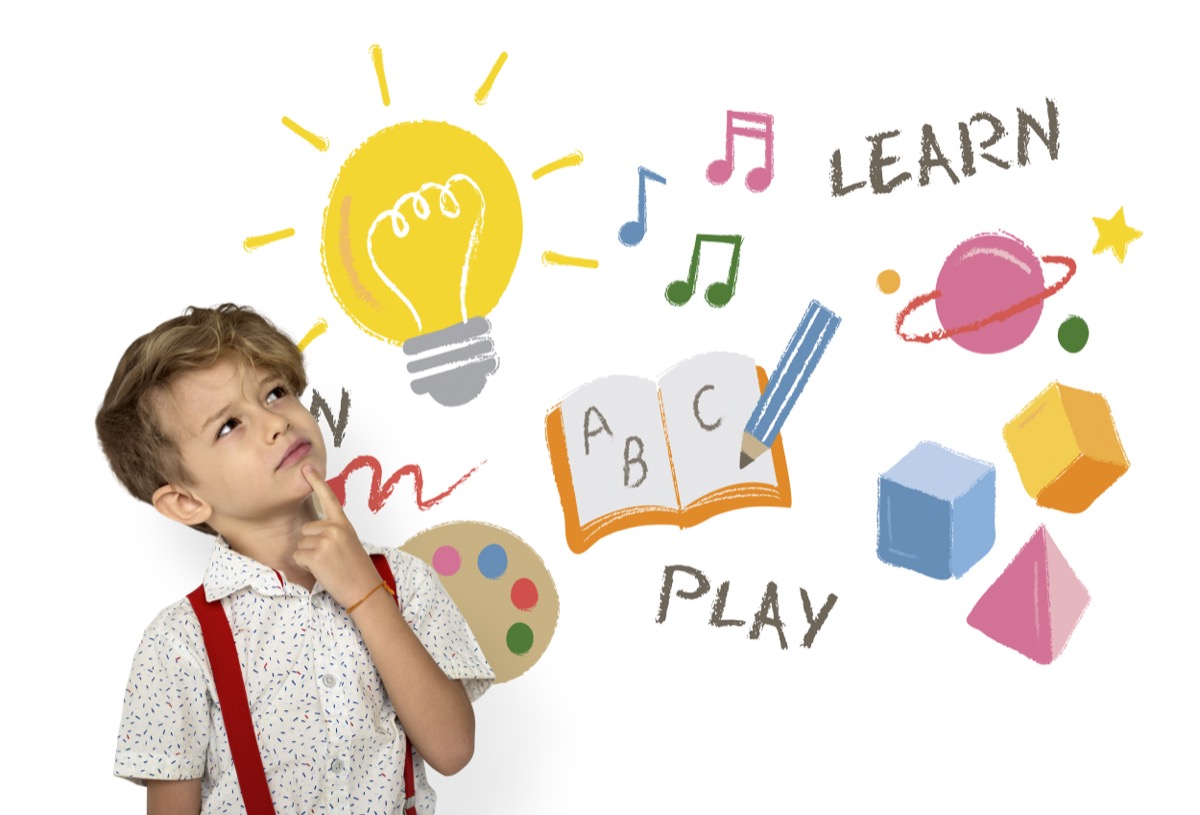Boy looking up at illustrated ideas: a lightbulb, music notes, a book, and a planet